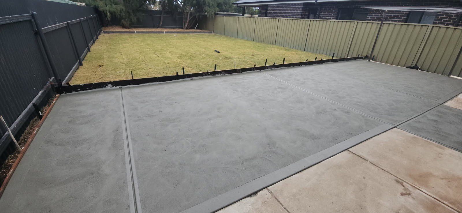 Finished concrete patio slab and prepared yard